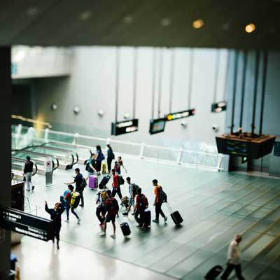 travelers walking through an airport