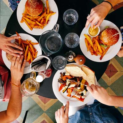 group of people eating food together.