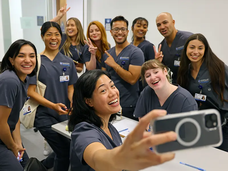 nursing students smiling and taking a group selfie
